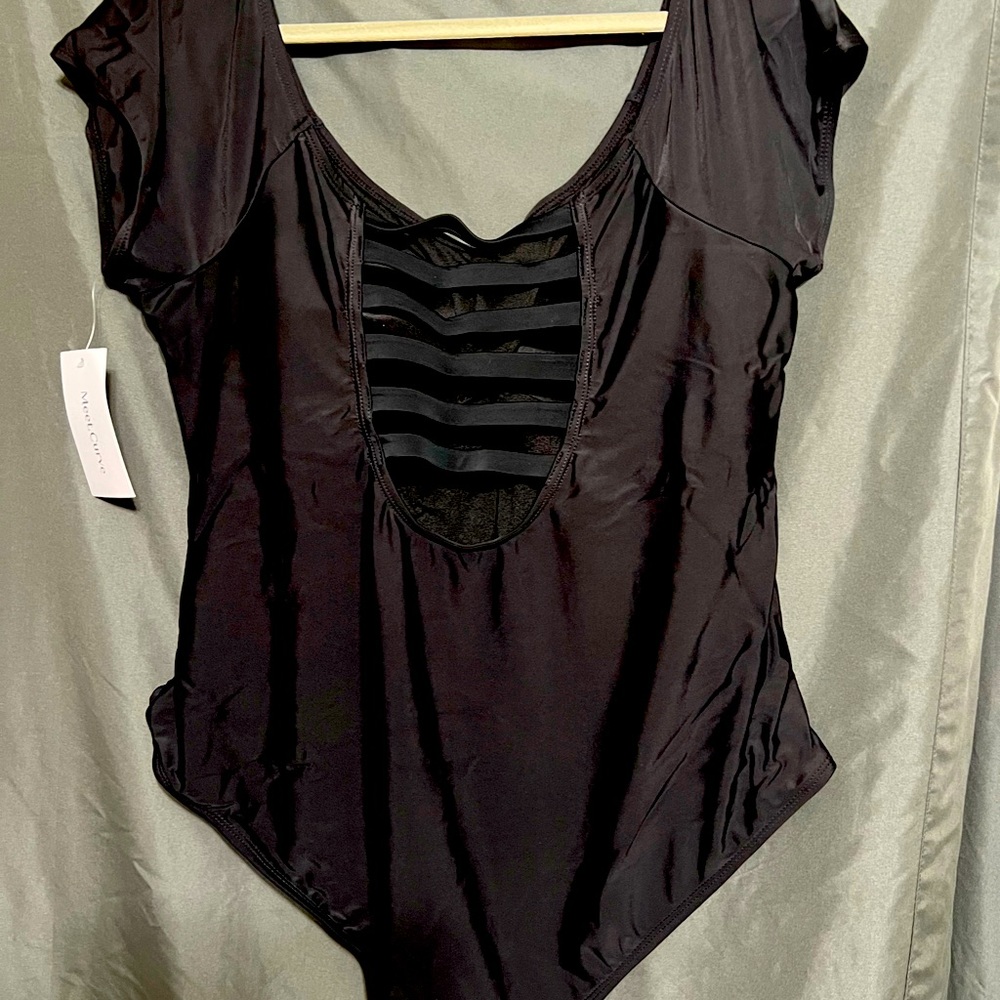 Scoop neck modest fit bathing suit with ladder opening back.  Size 3x  black